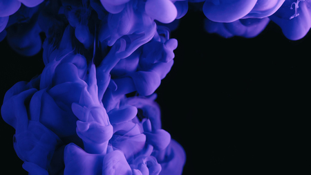 Violet ink in water shooting with high speed camera. Purple paint dropped, reacting, creating abstract cloud formations and metamorphosis on black. Art backgroundsの写真素材