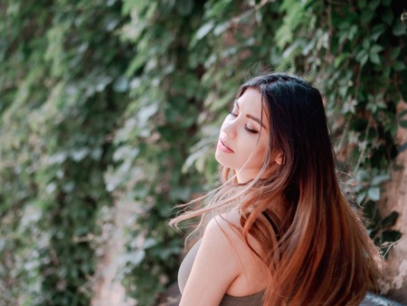 Portrait of young attractive girl with smile. Woman with oriental face, brown eyes and stylish ombre...