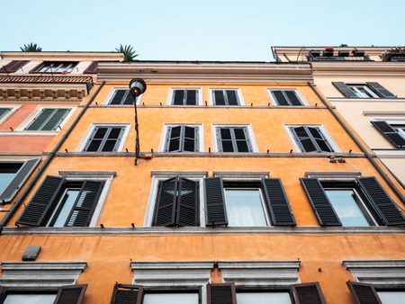 Beautiful facade of apartment building in Rome, Italy. Windows with shutters.の写真素材