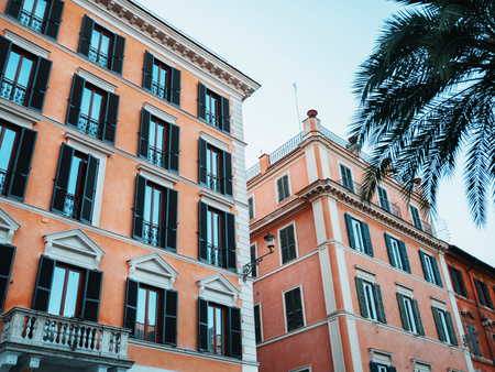 Beautiful facade of apartment building in Rome, Italy. Windows with shutters.の写真素材