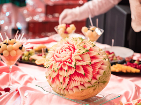 Close up of carved watermelon as rose in the restaurant. Carving on fruits and berries.の写真素材