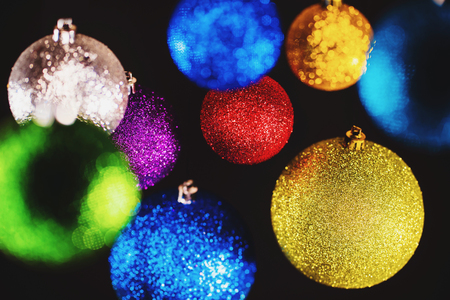 Christmas tree colorful toys. Shining balls on black wall. Decoration. Abstract holiday background. New 2019 year moodの写真素材