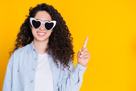 Smiling happy student girl showing eureka gesture. Portrait of young thinking business woman having...