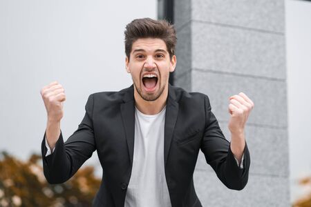 Portrait of angry furious businessman, having nervous breakdown at work, screaming in anger, stress management, mental distress problems, losing temper, reaction on failureの写真素材
