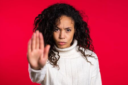 No, never, pretty african woman disliking and rejecting gesture by stop sign.の写真素材