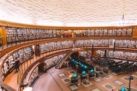 Public library with colorful books on shelfs. 14 February 2020, Stockholm Sweden