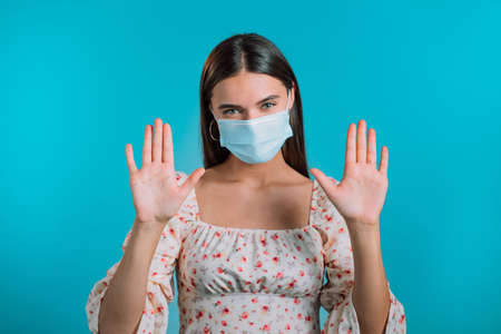 Woman in protective mask shows her hands - it is clean and sterile. Stop virus concept, bacteria protection.の写真素材