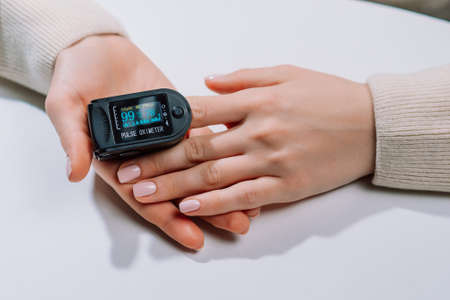 Measuring amount of oxygen in blood with pulse oximeter. Saturation and pulse checking at home, fast...