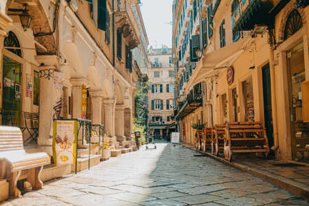 Corfu, Greece - September 2021. Beautiful cozy narrow street in old greek town. Historic european facades of buildings. Cityscape concept.のeditorial素材