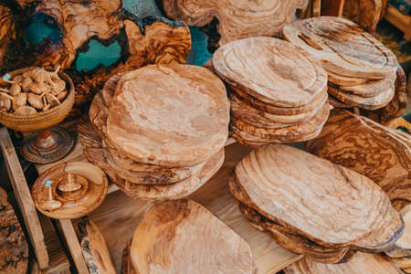 Products made from olive tree, wooden souvenirs on sale in Greece island - Corfu. Local market with craft kitchen accessories - cutting board, spoonsの写真素材