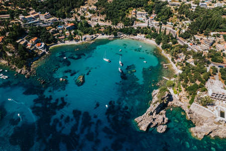 Aerial drone view to clear blue sea or ocean water. Amazing azure nature background. Clean light coast, travel destination.の写真素材