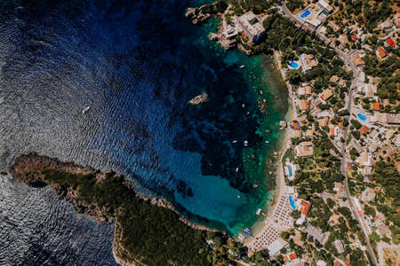 Aerial drone view to clear blue sea or ocean water. Amazing azure nature background. Clean light coast, travel destination.の写真素材