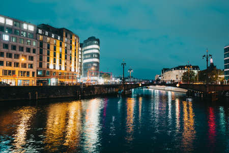 October 2021 - Berlin, Germany. Night view to historic busy street, bridge under river Spree. Long exposure, traffic on Friedrichstrasse in germanian capital.のeditorial素材