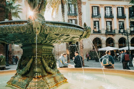 Beautiful historic fountain in Plaza Real in Barcelona, Spain. Famous square in Gothic quarter. Popular tourist attraction.の写真素材