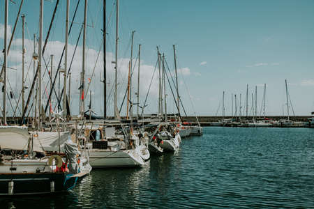 View to bay with sea water and moored boats, yachts. Amazing azure nature background. Anchoring in private beach on tropical island, travel destination.の写真素材