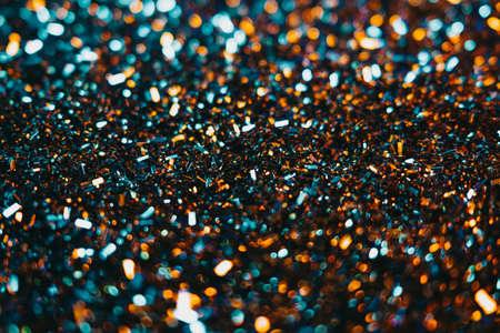 Festive glitter background. Colorful blue and orange light. Copy space for art party project....