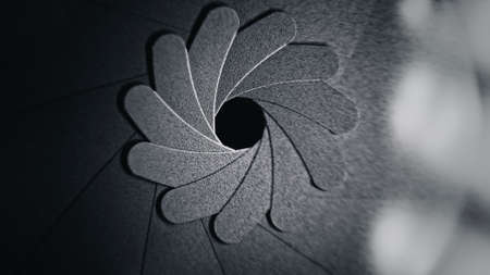 Adjusting aperture on camera lens. Close up view. Iris blades. Technology, camera, shooting...