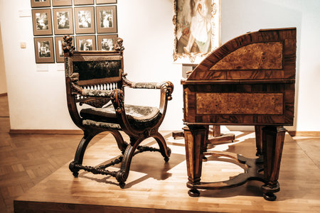 Prague, Czech Republic - July 2022. Alphonse Mucha Museum. The painters desk, chair and tools. Gallery dedicated to renowned painter, illustrator, graphic artist.のeditorial素材