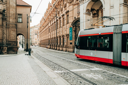 Prague, Czech Republic - July 2022. Modern tram on beautiful cozy street in old town. Urban public transport. Amazing european architecture, historical facades of traditional buildingsのeditorial素材