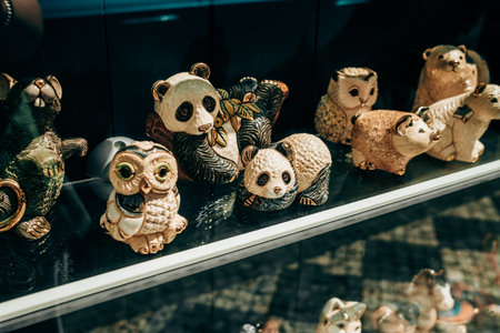 Prague, Czech Republic - July 2022. Souvenir shop window - cute animals figures panda, owl, bear and pig. Toys, beautiful gift from trip.のeditorial素材