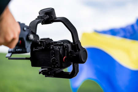 Video camera man operator working with professional equipment, filming, recording. Cameraman shooting videoの写真素材