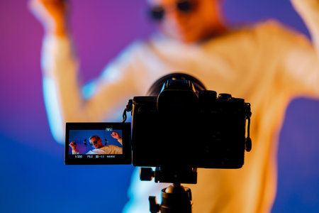 Backstage how operator working with professional camera. Videographer shoots music clip with actor...