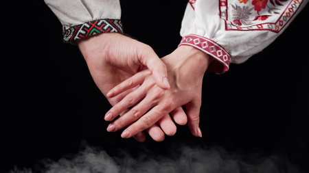 Young ukrainian couple in embroidered national shirts holding hands. Man womanの写真素材