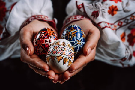 Ukrainian woman hand painted Easter eggs. Geometric slavic decoration ornaments