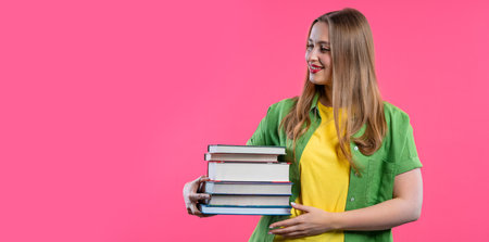 Adult happy student woman with stack of books from library on pink background. Happy girl smiles,...