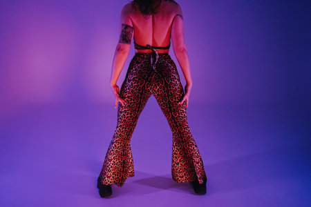 Sexy woman in leopard pants dancing modern dance - twerk. Girl shaking, twerking her buttocks close...