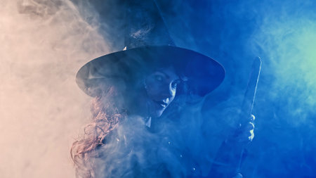 Classic witch flying on broom at misty blue sky at night. Halloween masquerade