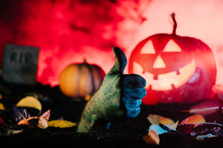 Terrible zombie hand thumb up sign, like gesture from grave. Halloween concept.の写真素材