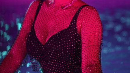 Unrecognizable glamorous woman pool water party under neon glowing, sexy outfit