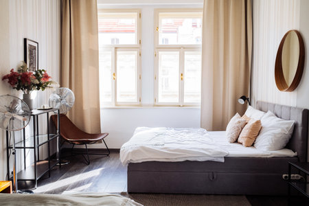 Cozy stylish bedroom design in light colors. Luxury apartments, comfortable room