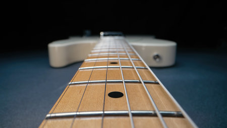 Macro of strings on electric guitar fretboard. Details of instrument close-upの写真素材