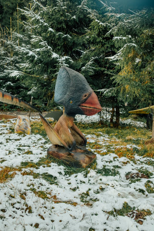 Bukovel, Ukraine - December 2023. Attraction statue of dinosaurs model in Dinopark, winter forest park in natureのeditorial素材