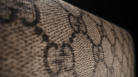 15 February 2024 - Milan, Italy. Gucci monogram background, brand label logo.のeditorial素材