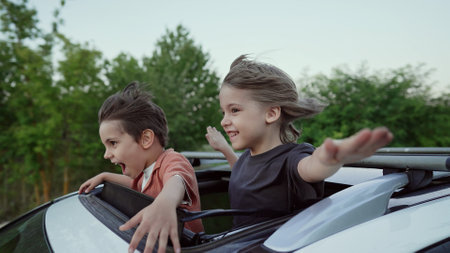 Funny Happy Little Boys Stands In Open Car Sunroof During Trip, Summer.Childhoodの写真素材