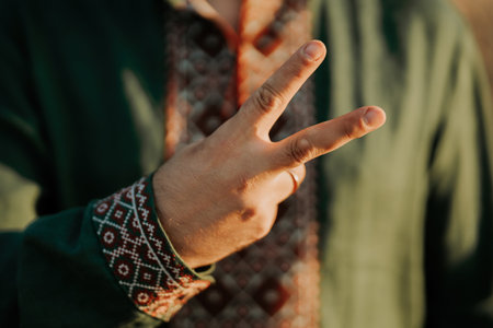 Ukrainian man in vyshyvanka shirt showing hand With Peace Sign,V Victory Gestureの写真素材