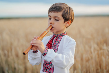 Little Boy Playing Folk On Woodwind Wooden Flute - Ukrainian Sopilka Or Tylynkaの写真素材