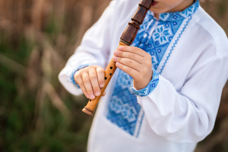 Hands Of Little Boy Kid Playing On Woodwind Wooden Flute - Ukrainian Sopilkaの写真素材