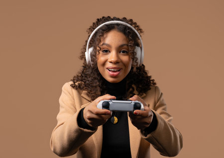 Young african teenager girl playing online video game, console TV with joystick