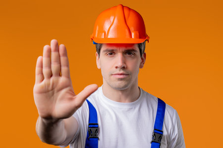 Serious handyman showing Rejecting Gesture By Stop Palm. Not Allow, Prohibitionの写真素材