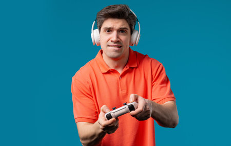 Mature 30s man playing online video game on console TV with joystick. e-sport