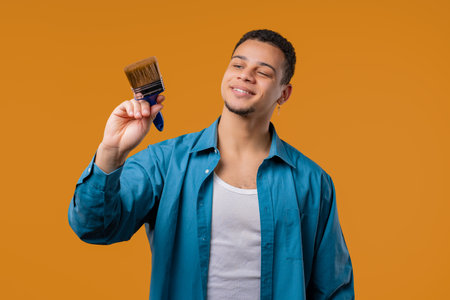 Creative painter artist man with brush on Yellow background. Fantasy, ideaの写真素材