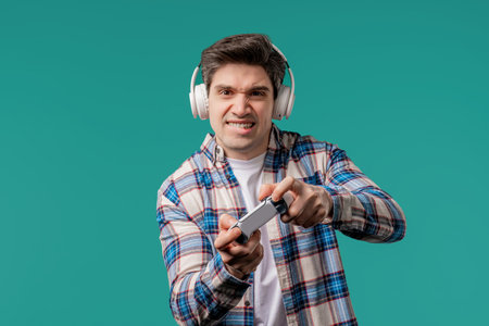 Mature 30s man playing online video game on console TV with joystick. e-sportの写真素材