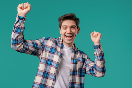 Active positive man dancing on blue background. Funny dance, great mood vibesの写真素材