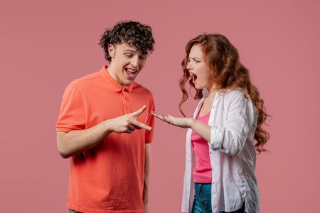 Positive funny couple playing rock paper scissors. Rochambeau team games. Settling dispute method, decisionの写真素材
