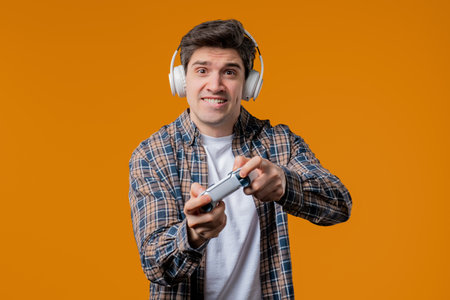 Mature 30s man playing online video game on console TV with gamepad. e-sport