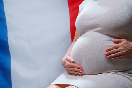 Unrecognizable Future Mother Expecting Baby On French National Flag Backgroundの写真素材